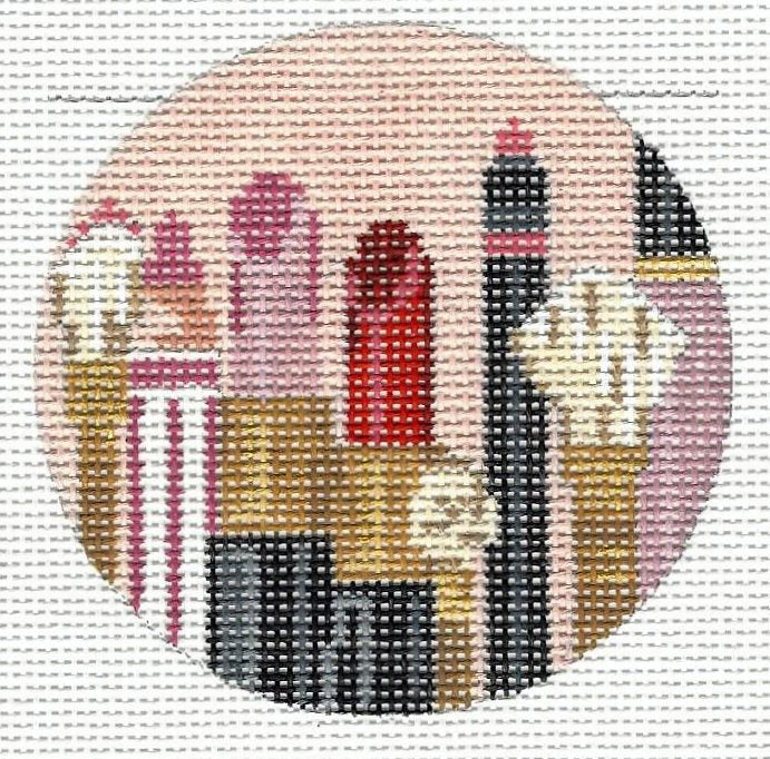 Kelly Clark round needlepoint canvas of colorful makeup tools with light pink background and rose pink and red lip palette