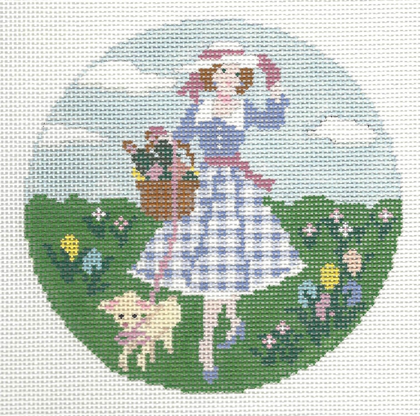 Gingham Stitchery needlepoint canvas of a girl in a blue dress with a basket and a lamb, standing in a field of flowers