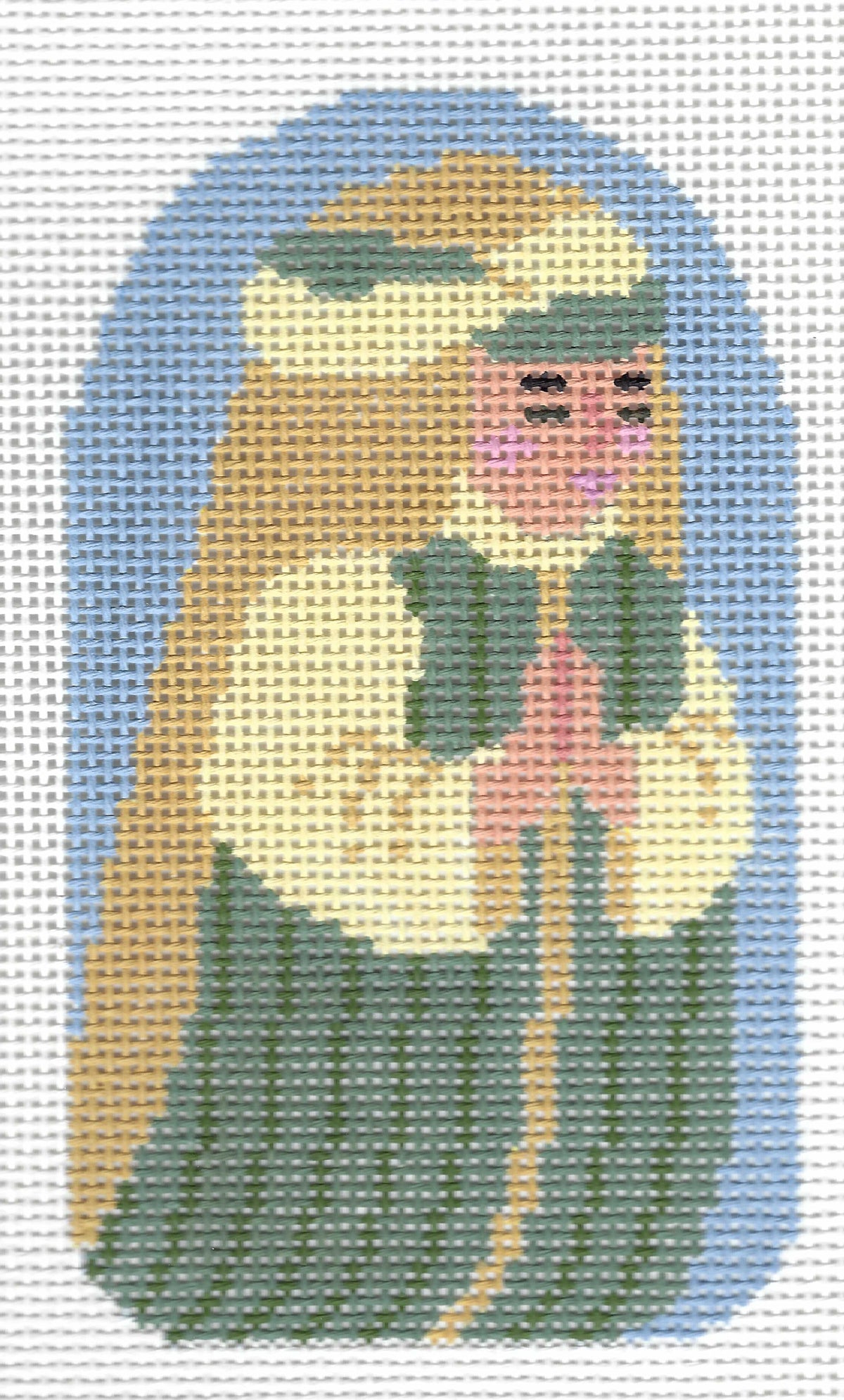The Collection needlepoint canvas featuring a stylized cross-stitched design of a kneeling shepherd with long brown hair, a white head covering, and a pink face, set against a light blue arched background.