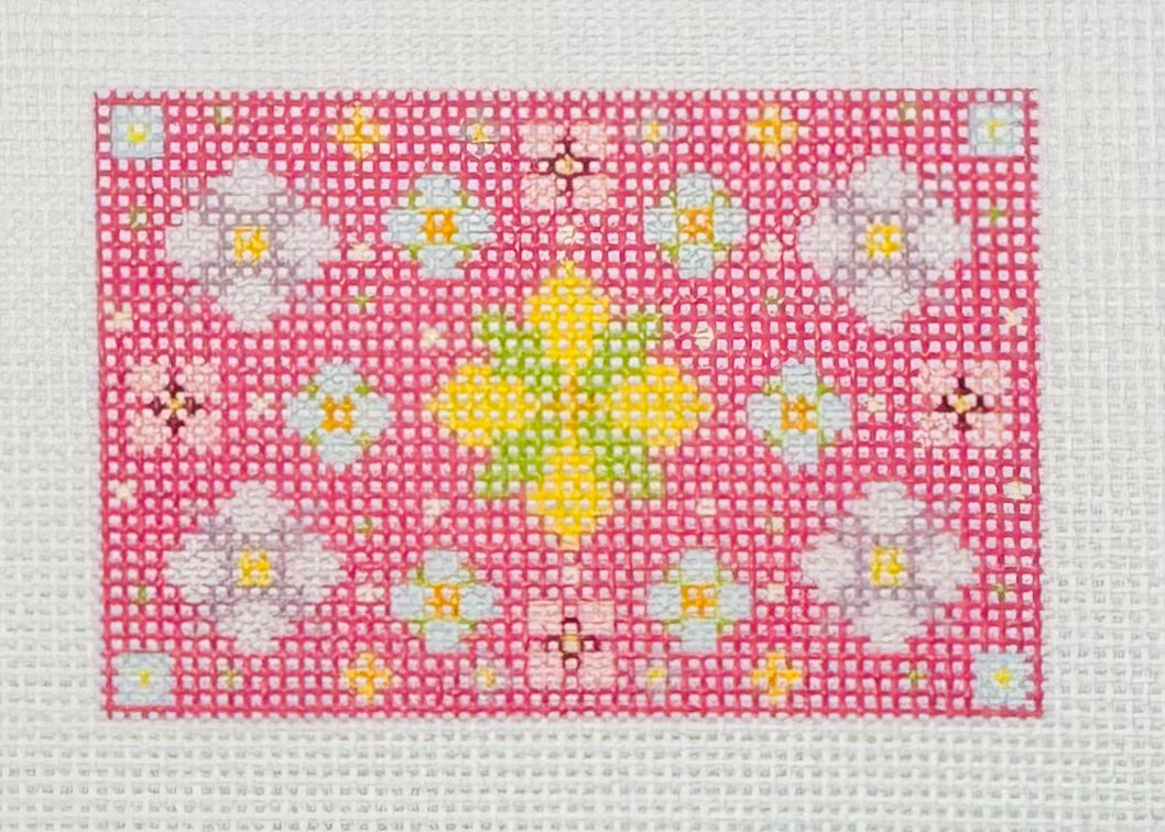Tilli Tomas Planet Earth needlepoint canvas of floral mandala pattern on a pink background