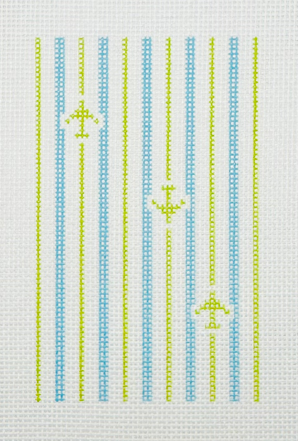 Tilli Tomas Planet Earth needlepoint canvas of design with aqua stripes and lime green stripes and airplanes