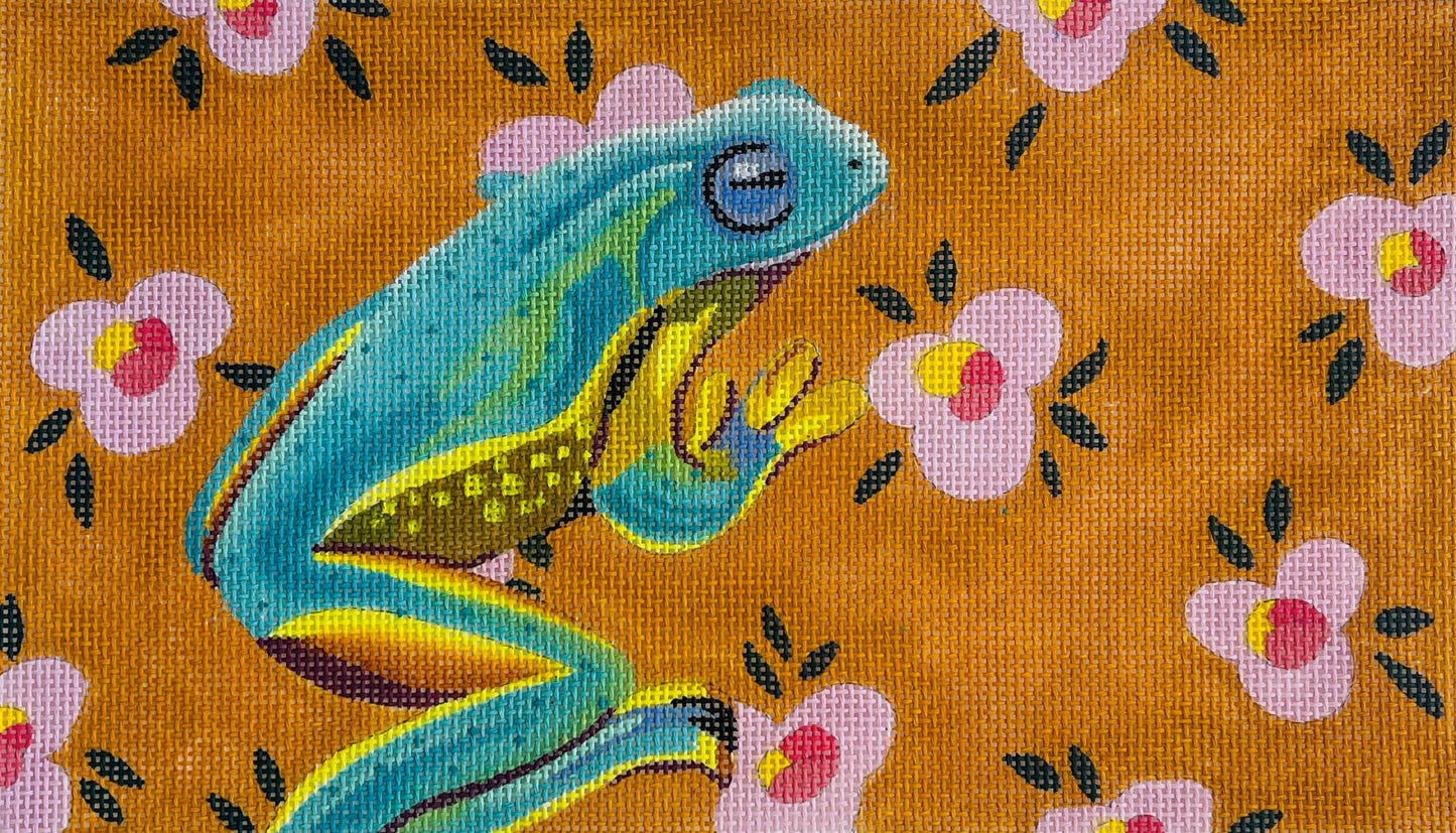 Colors of Praise needlepoint canvas of a colorful frog illustration on a floral patterned background