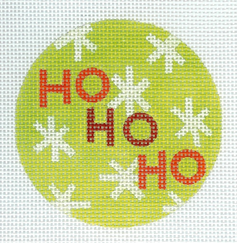 Kirk & Bradley round ornament needlepoint canvas of 'HO HO HO' text in red on a green background with white snowflakes.