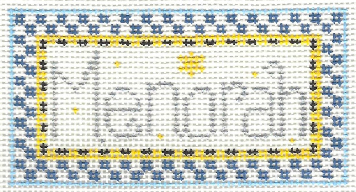 Kathy Schenkel needlepoint canvas of 'Menorah' text with a blue and yellow border on a white background