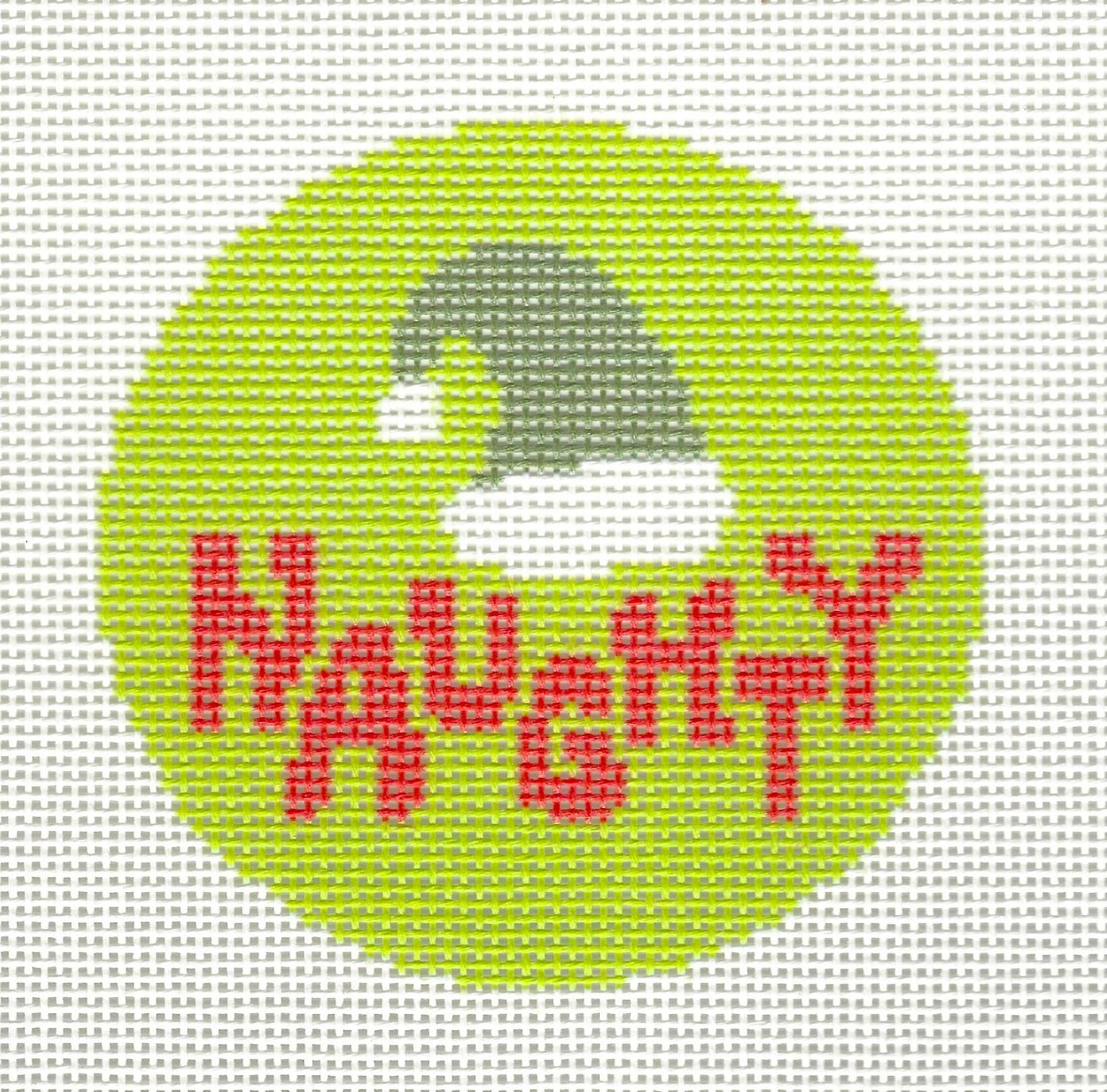 KCN Designers round ornament needlepoint canvas of green Santa hat and red text 'Naughty' on a lime green background.