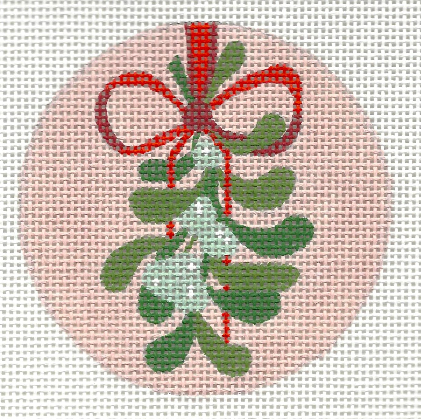 Raymond Crawford Designs needlepoint canvas containing decorative green mistletoe with a red bow and a pink background