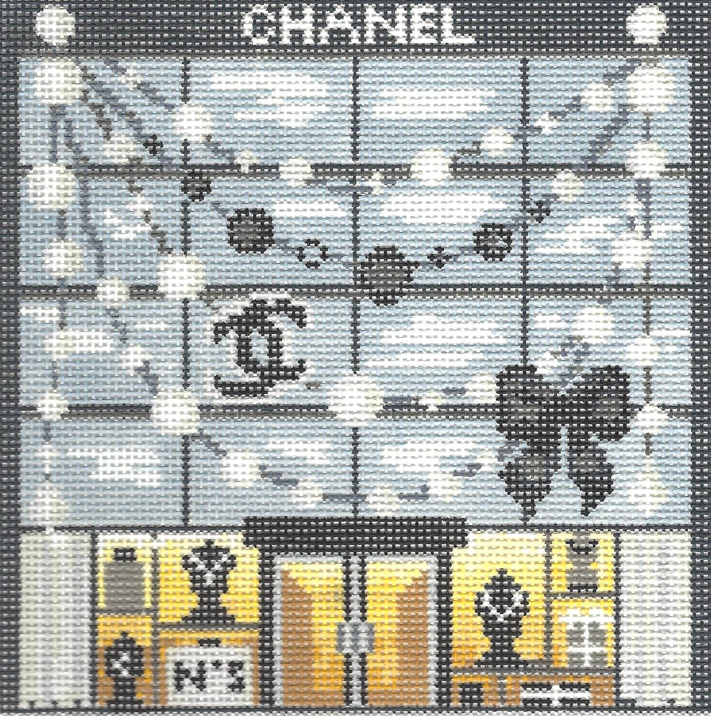 Gingham Stitchery needlepoint canvas of luxury storefront