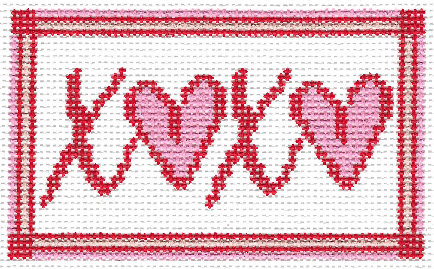 Atlantic Blue Canvas Stitching Sue needlepoint canvas featuring the word 'XOXO' in red letters, with the 'O' letters forming two pink hearts, set within a red stitched border on a white background.