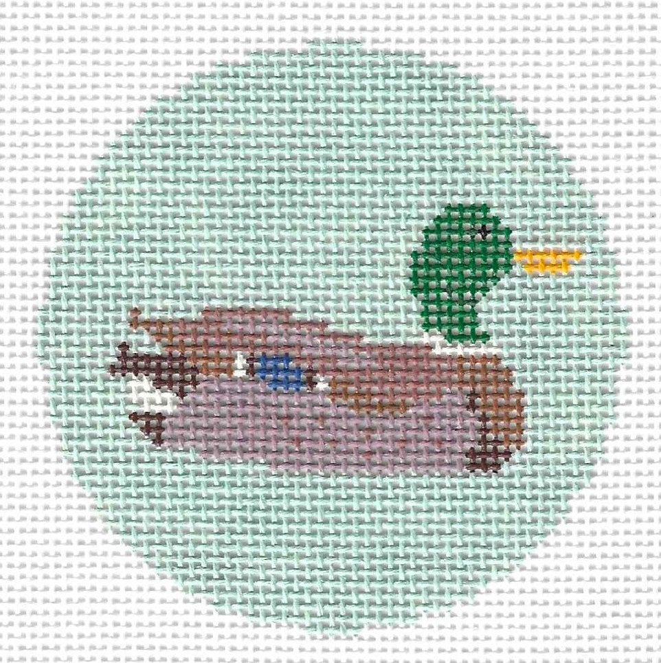 Maura Nolan round needlepoint canvas of a duck on a light green background.