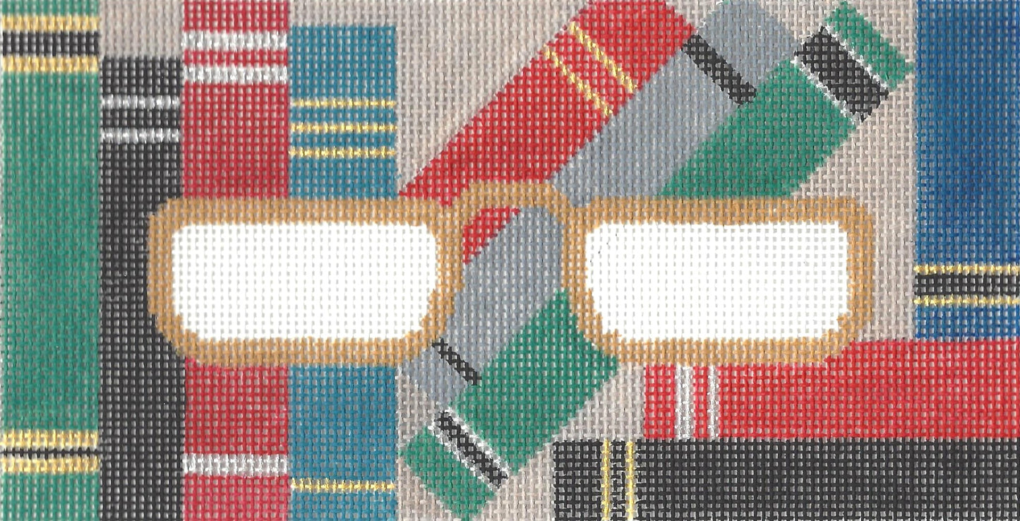 J. Malahy Designs needlepoint canvas of eyeglass case with books and glasses outlined in gold.