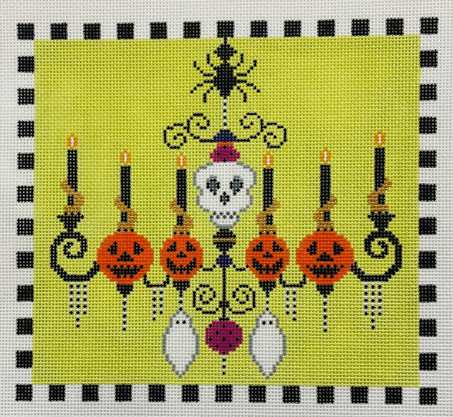 Shelly Tribbey needlepoint canvas of Halloween-themed chandelier with candles, jack-o'-lanterns, and a skeleton on a green background.