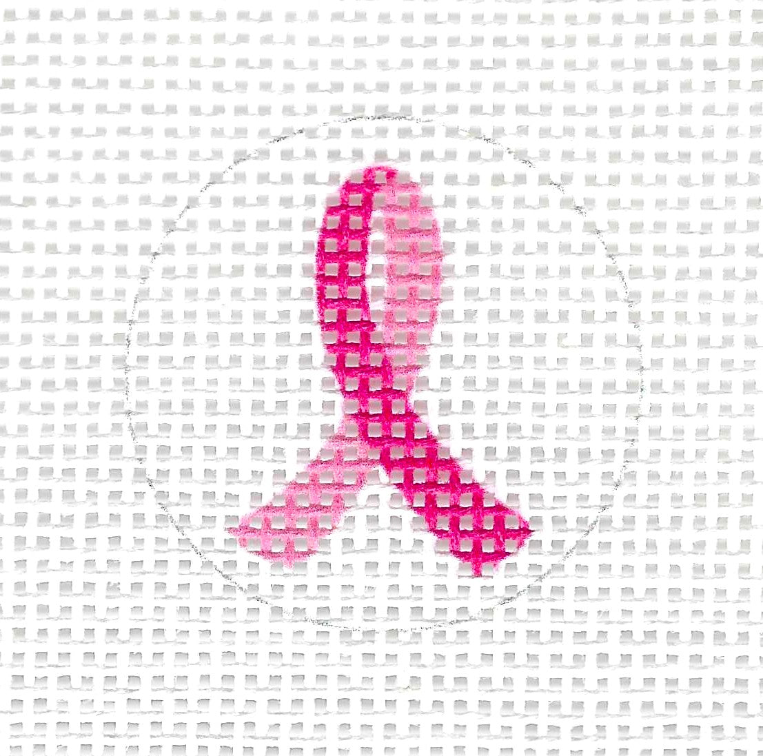 Tilli Tomas Planet Earth round needlepoint canvas of a pink awareness ribbon on a white background.