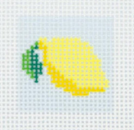 Tilli Tomas Planet Earth needlepoint canvas of a lemon with a green leaf on a white background.