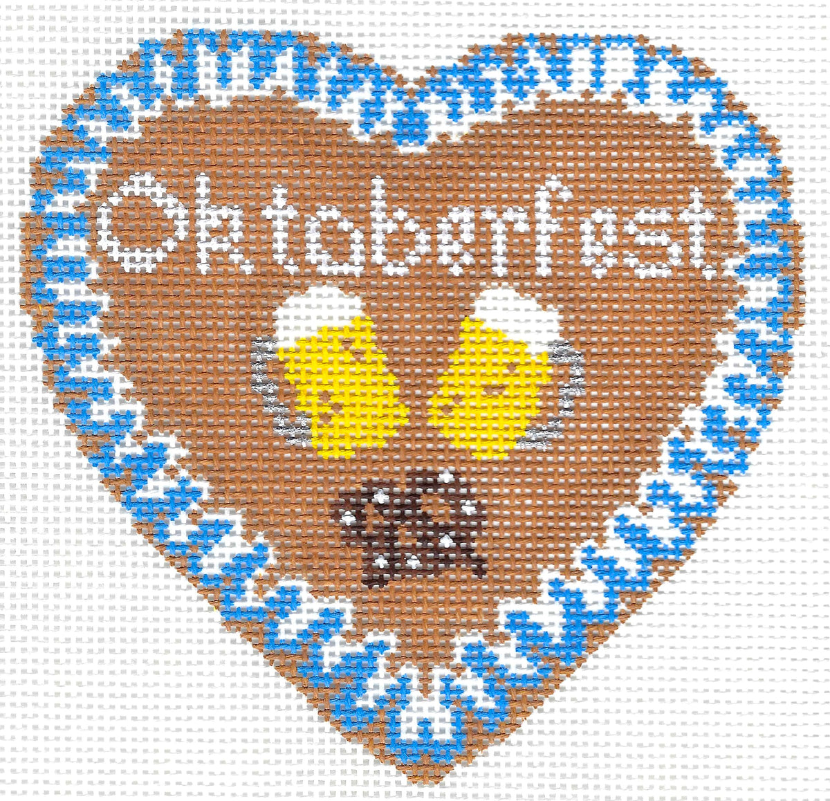 Blue Ridge Stitchery needlepoint canvas of a brown heart-shaped design featuring the word 'Oktoberfest' in white, two yellow beer mugs with white foam, and a brown pretzel, surrounded by a blue-and-white patterned border on a white background.