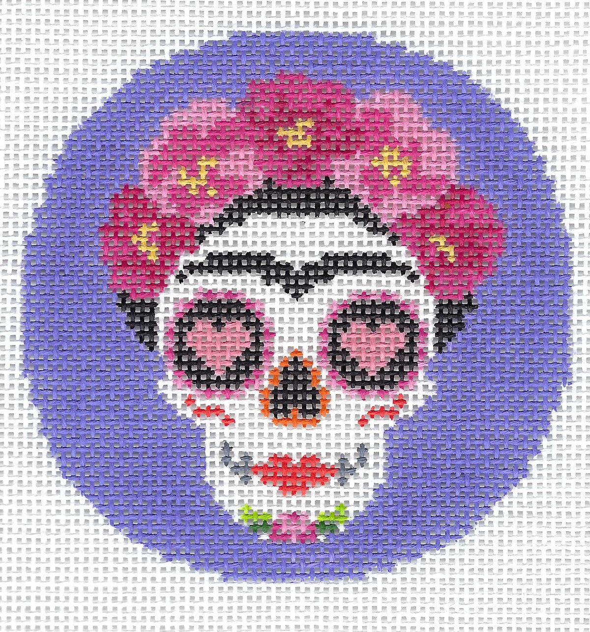Pepperberry Designs round needlepoint canvas of a Day of the Dead sugar skull with pink flowers in a crown, centered on a purple background.