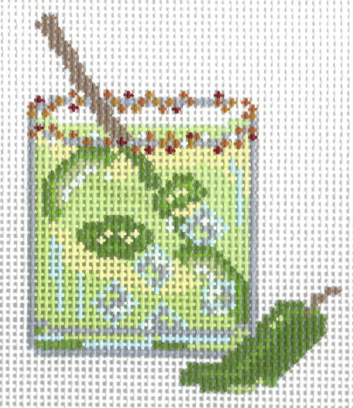 The Painted Stitch needlepoint canvas of a green margarita cocktail with a red and orange rim and jalapenos.
