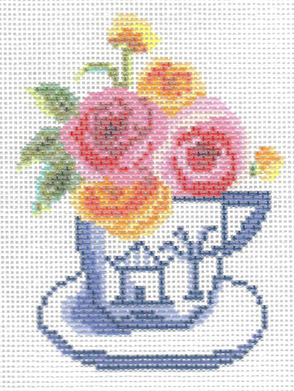 KCN Designers needlepoint canvas of a white and blue teacup with pink and yellow flowers on a white background