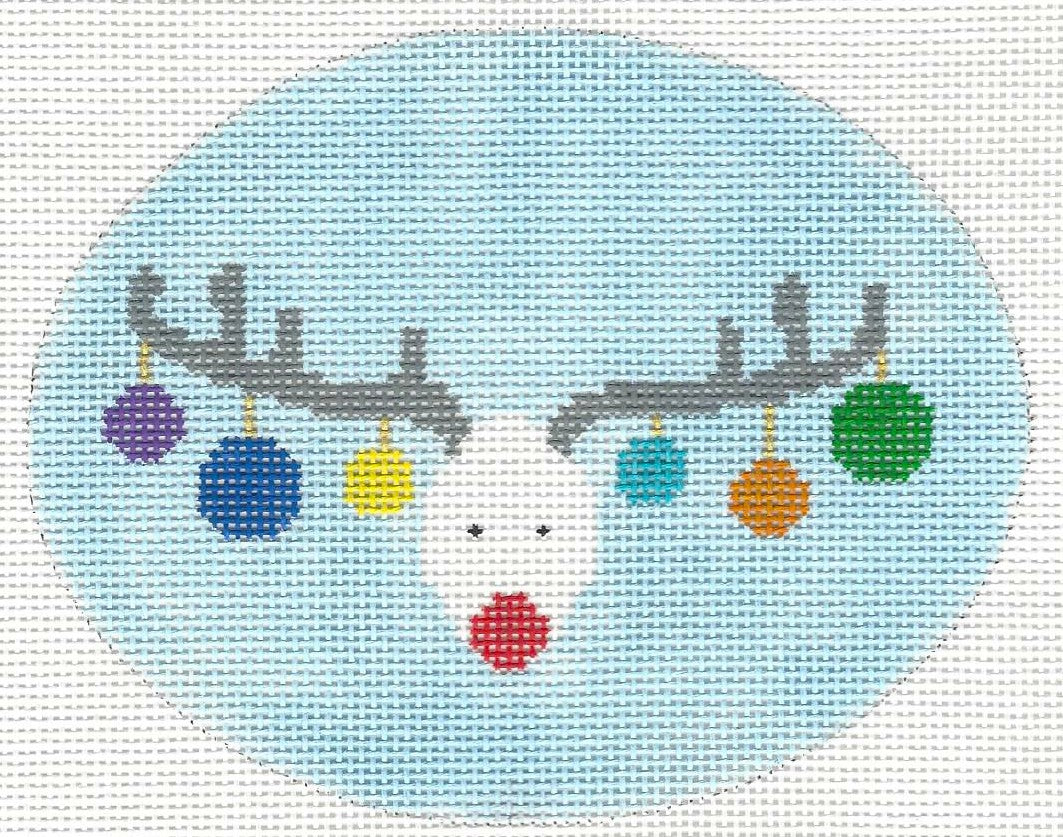 Burnett & Bradley needlepoint canvas of reindeer face with colorful ornaments on antlers with a light blue background