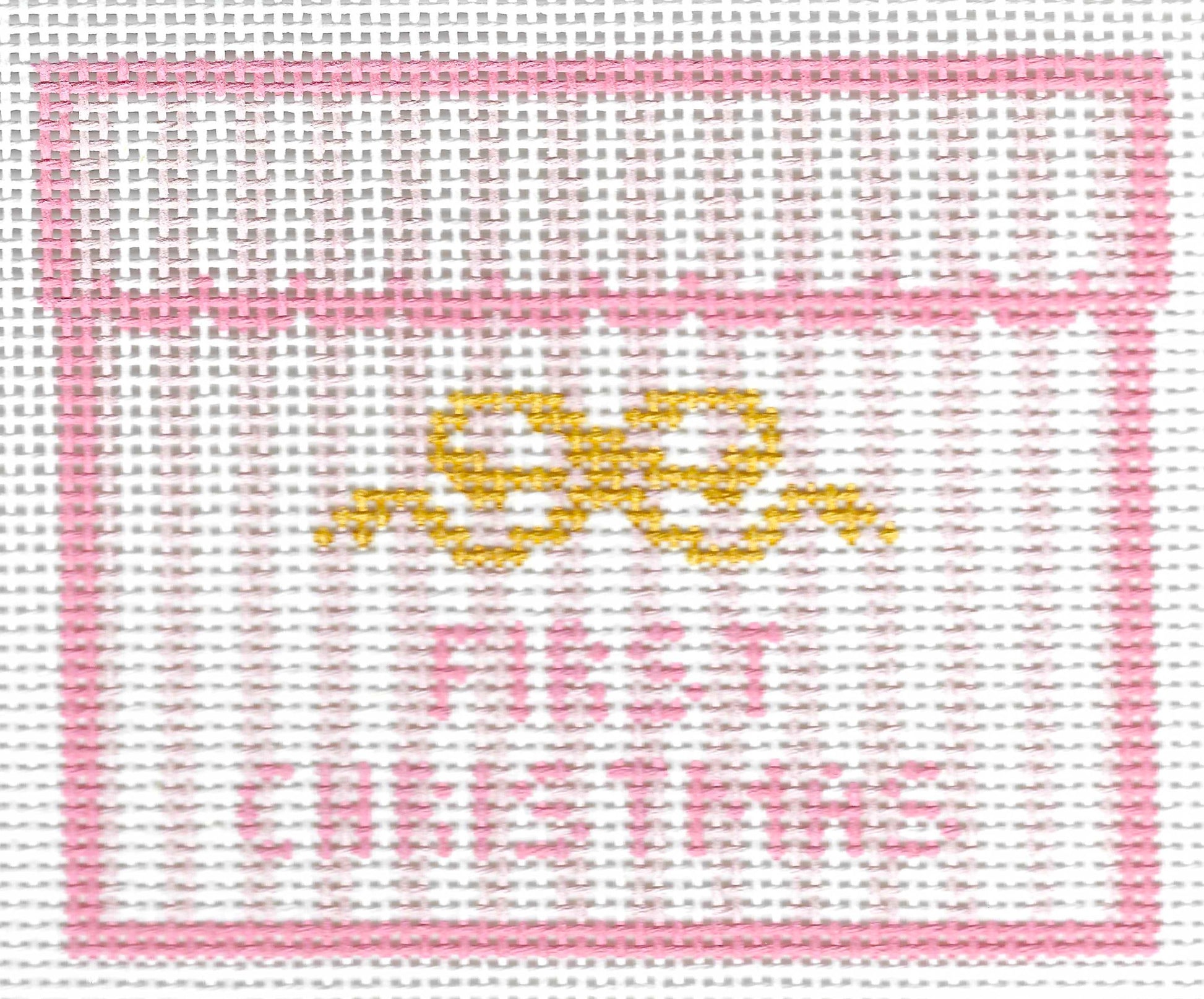 SLS Needlepoint canvas design featuring a pink border, a yellow bow motif, and the words 'FIRST CHRISTMAS' in pink on a white background.
