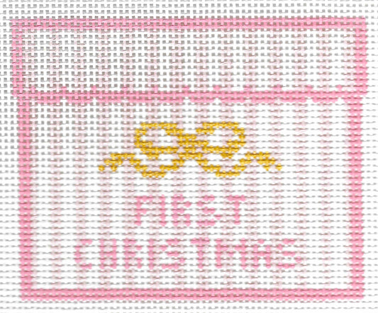 SLS Needlepoint canvas design featuring a pink border, a yellow bow motif, and the words 'FIRST CHRISTMAS' in pink on a white background.