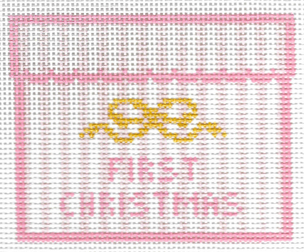 SLS Needlepoint canvas design featuring a pink border, a yellow bow motif, and the words 'FIRST CHRISTMAS' in pink on a white background.