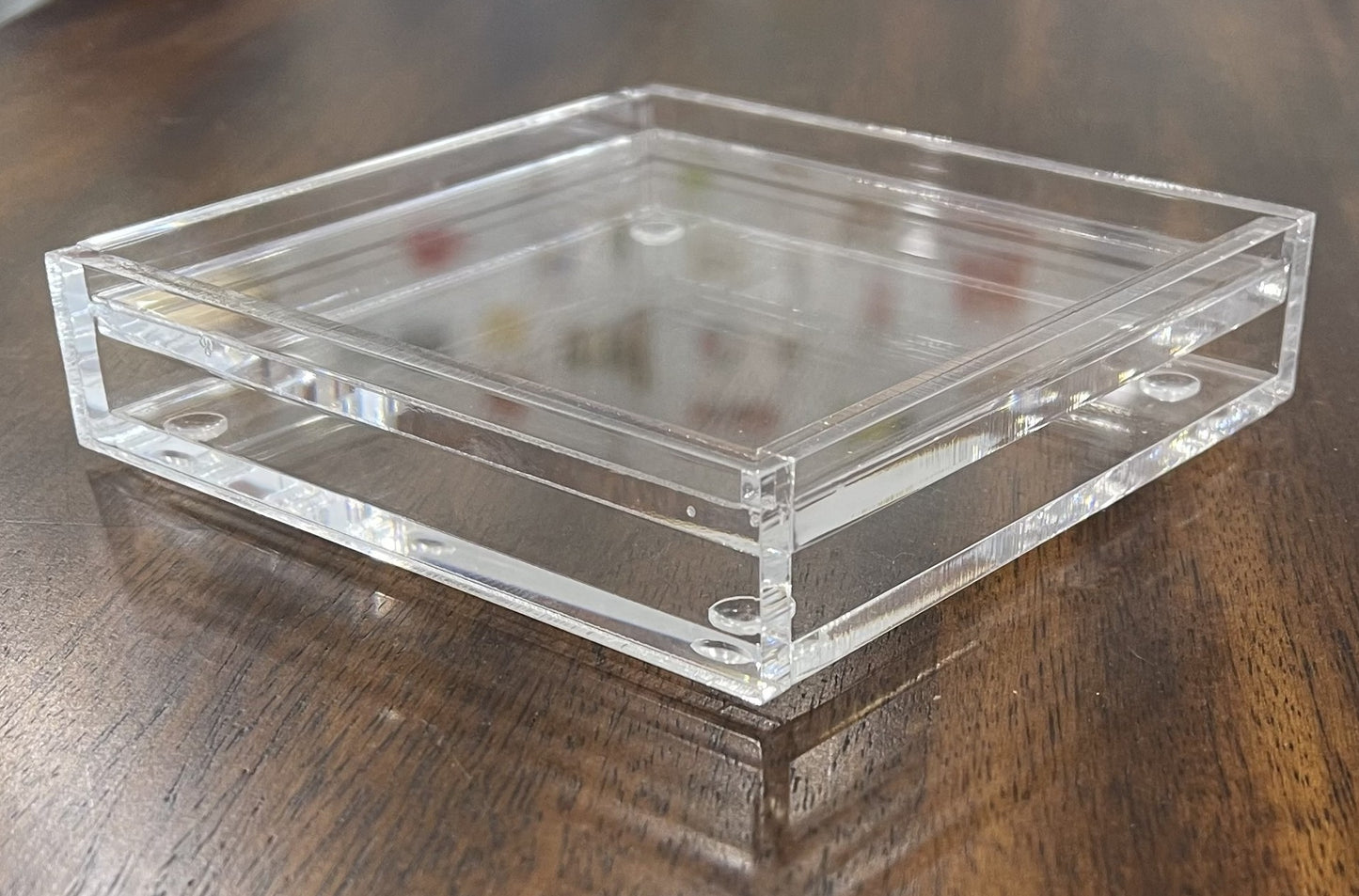 Acrylic 4" coaster on a wooden surface.