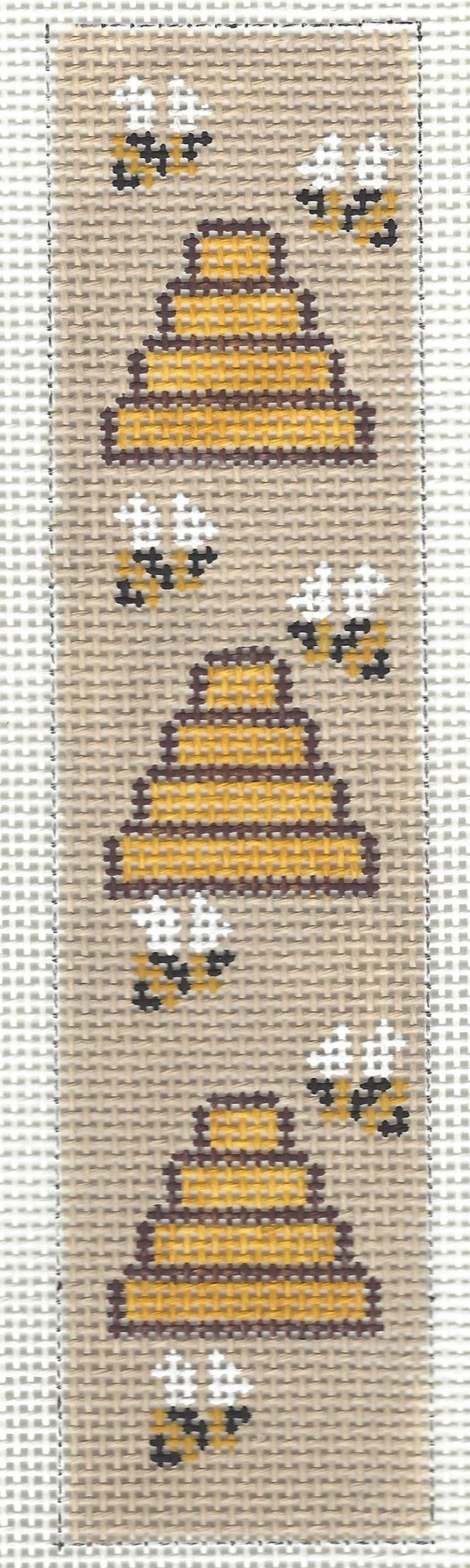 j. childs bookmark needlepoint canvas of beehives and bees on a beige background