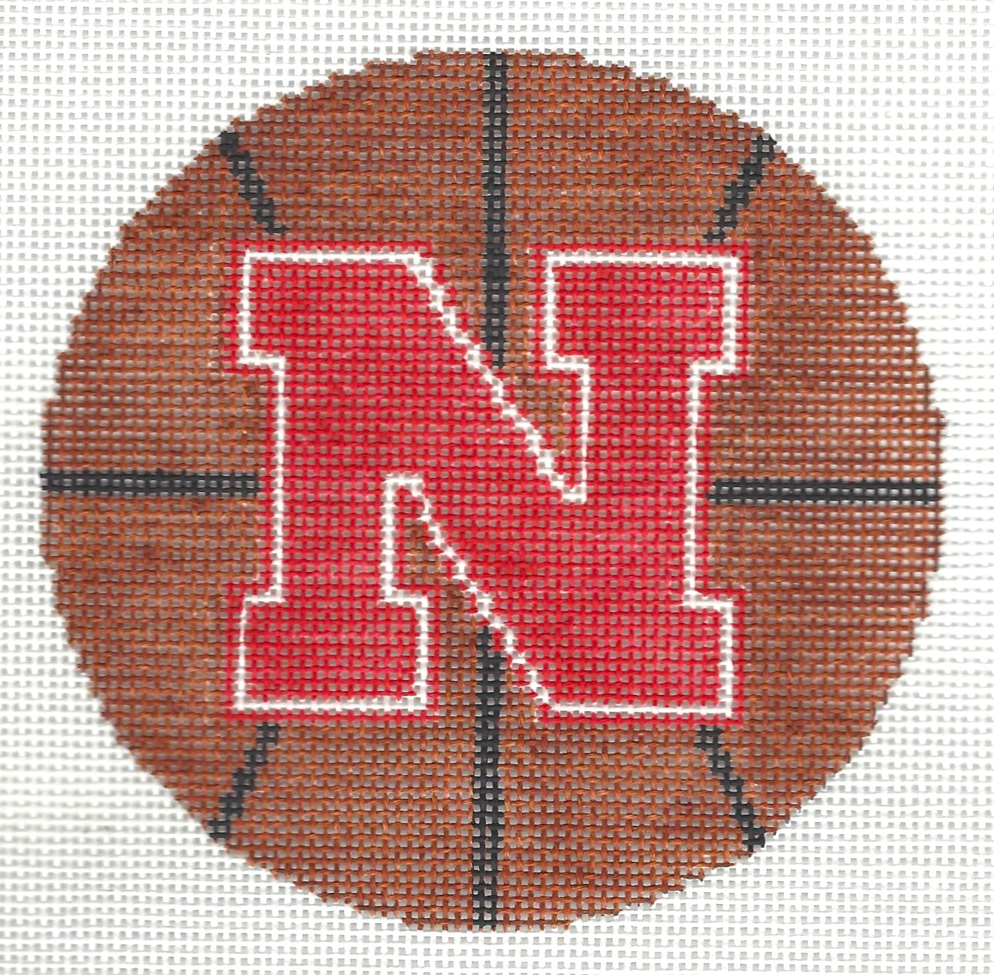 The Meredith Collection round needlepoint canvas of a basketball with a red 'N'