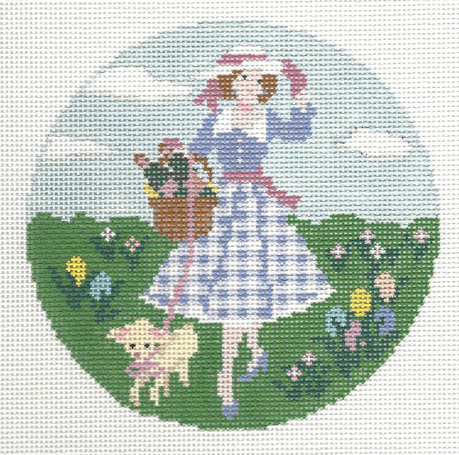 Gingham Stitchery needlepoint canvas of a girl in a blue dress with a basket and a lamb, standing in a field of flowers