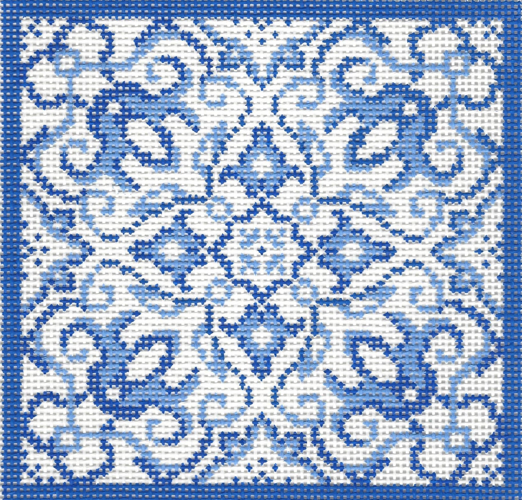 Treglown needlepoint canvas of blue and white geometric pattern with a blue border