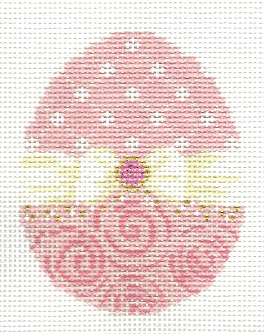 Kelly Clark needlepoint canvas of egg with  different patterns on the top and bottom with a cream-colored bow in the middle