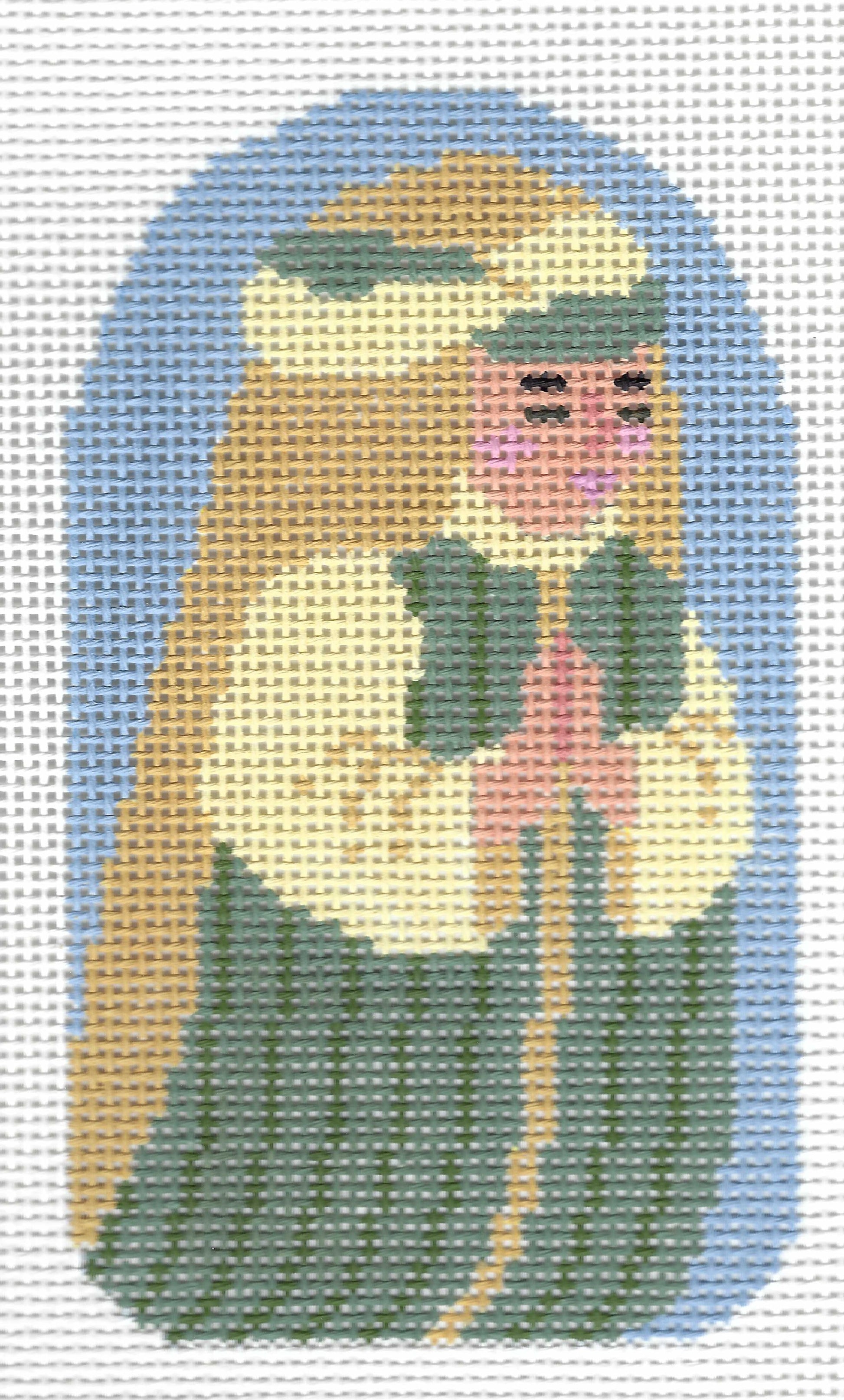 The Collection needlepoint canvas featuring a stylized cross-stitched design of a kneeling shepherd with long brown hair, a white head covering, and a pink face, set against a light blue arched background.