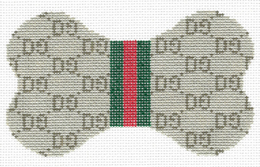 Lauren Bloch dog bone-shaped needlepoint canvas featuring a GG monogram pattern in beige and brown on a white background, with a central green and red web stripe.