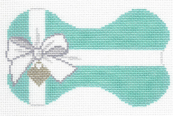 Lauren Bloch Designs bone-shaped needlepoint canvas in teal featuring a white bow with a silver heart hanging from the bow on a white background.