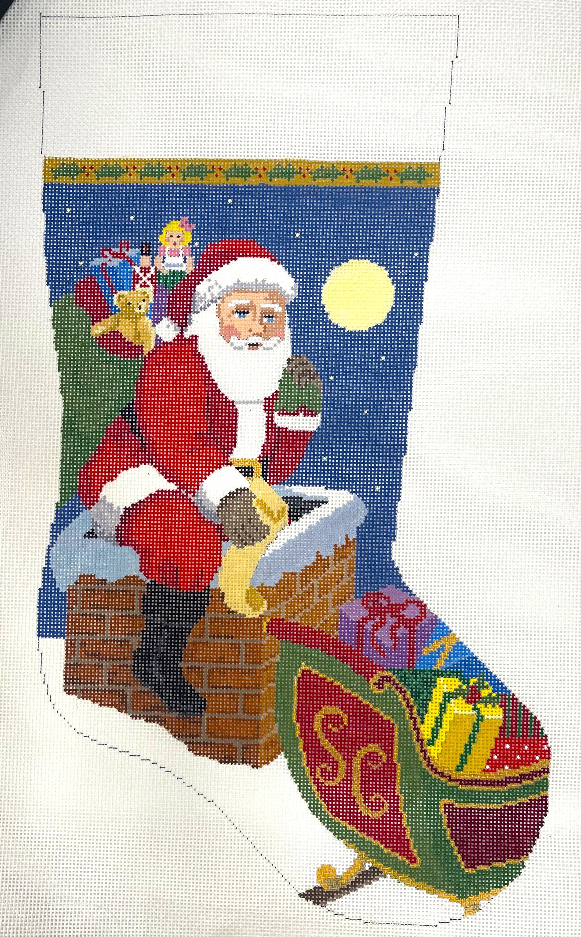 Susan Roberts needlepoint canvas of Christmas stocking with Santa Claus climbing into chimney with bag of toys.