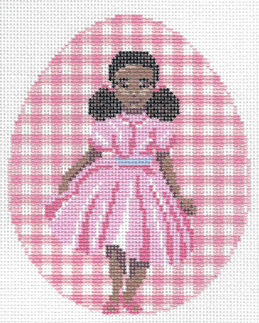 Spellbound Stitchery needlepoint canvas featuring a girl with dark hair in a pink dress, set against a pink and white gingham patterned oval on a white background.