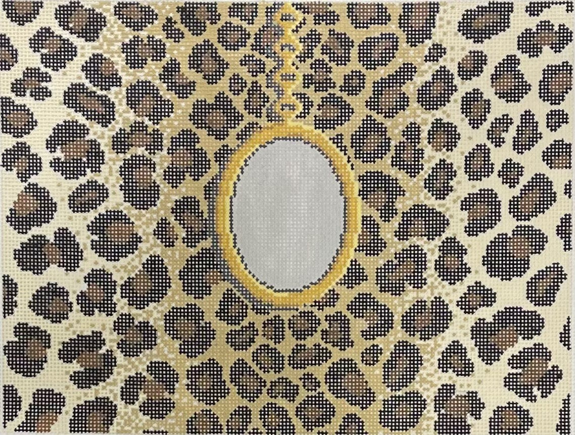 Jeni Sandberg needlepoint canvas of clutch with gold pendant on a leopard print background