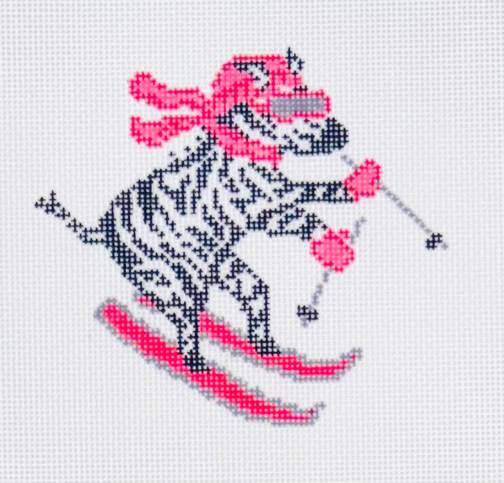 KCN Designers needlepoint canvas of la dolce vita alpine zebra skiing with pink skis, gloves, scarf, and goggles