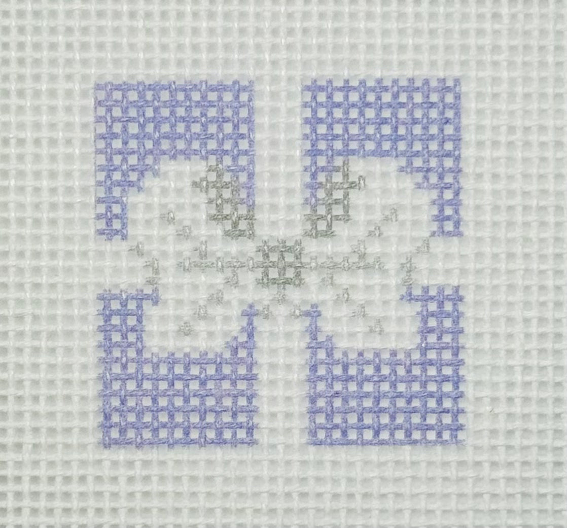 Tilli Tomas Planet Earth needlepoint canvas of top of purple gift with a silver bow