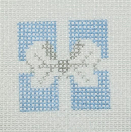 Tilli Tomas Planet Earth needlepoint canvas of top of light blue gift with a silver bow