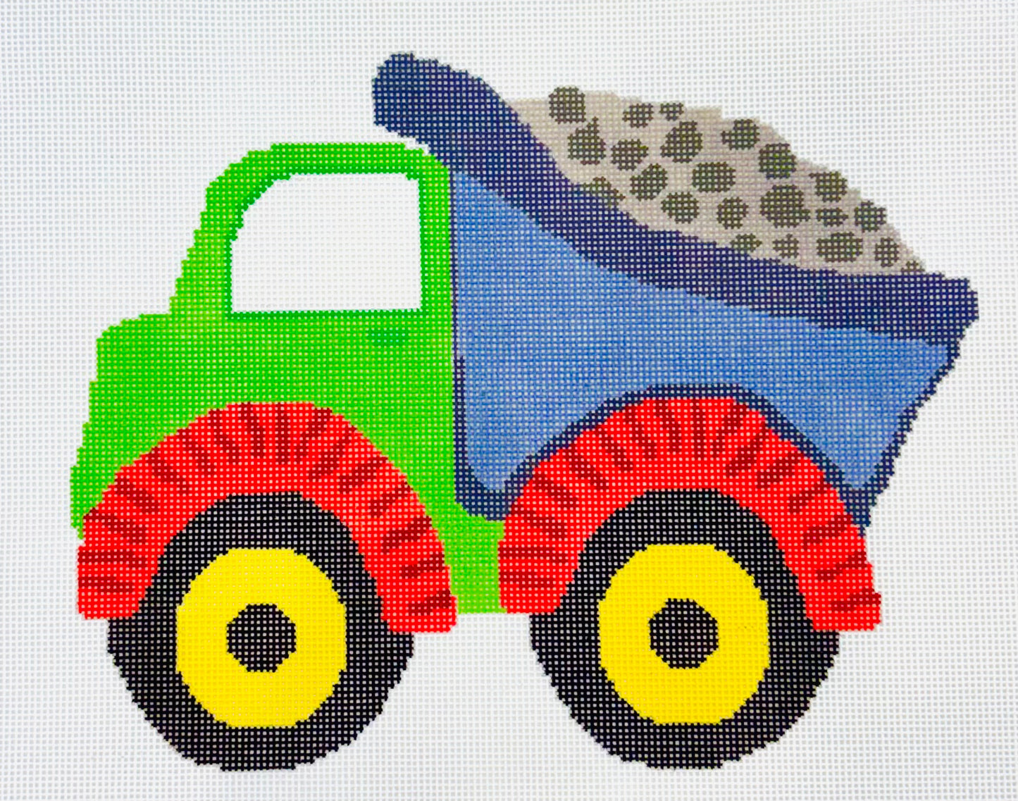 A Stitch in Time needlepoint canvas of colorful dump truck with green body, blue bed, red wheels with yellow centers on a white background