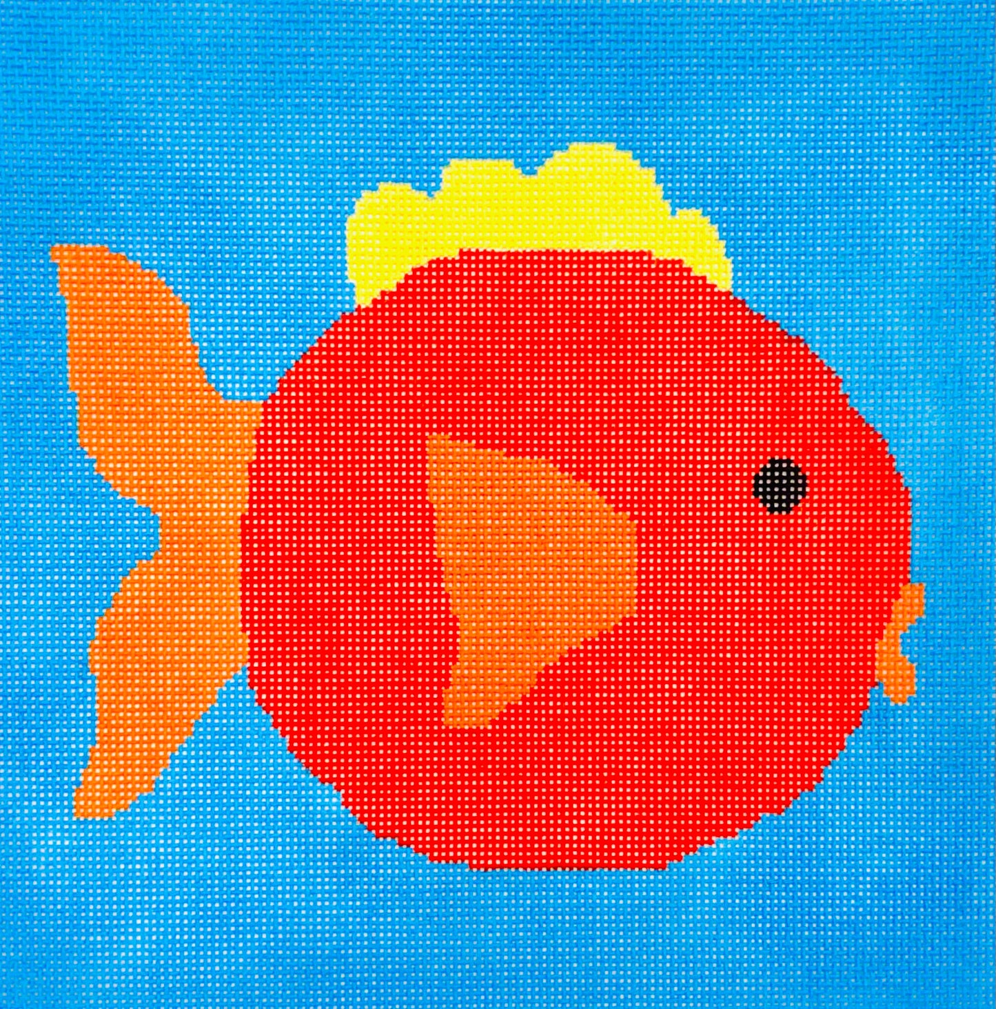 A Stitch in Time needlepoint canvas of red fish with orange and yellow fins/tail on a blue background
