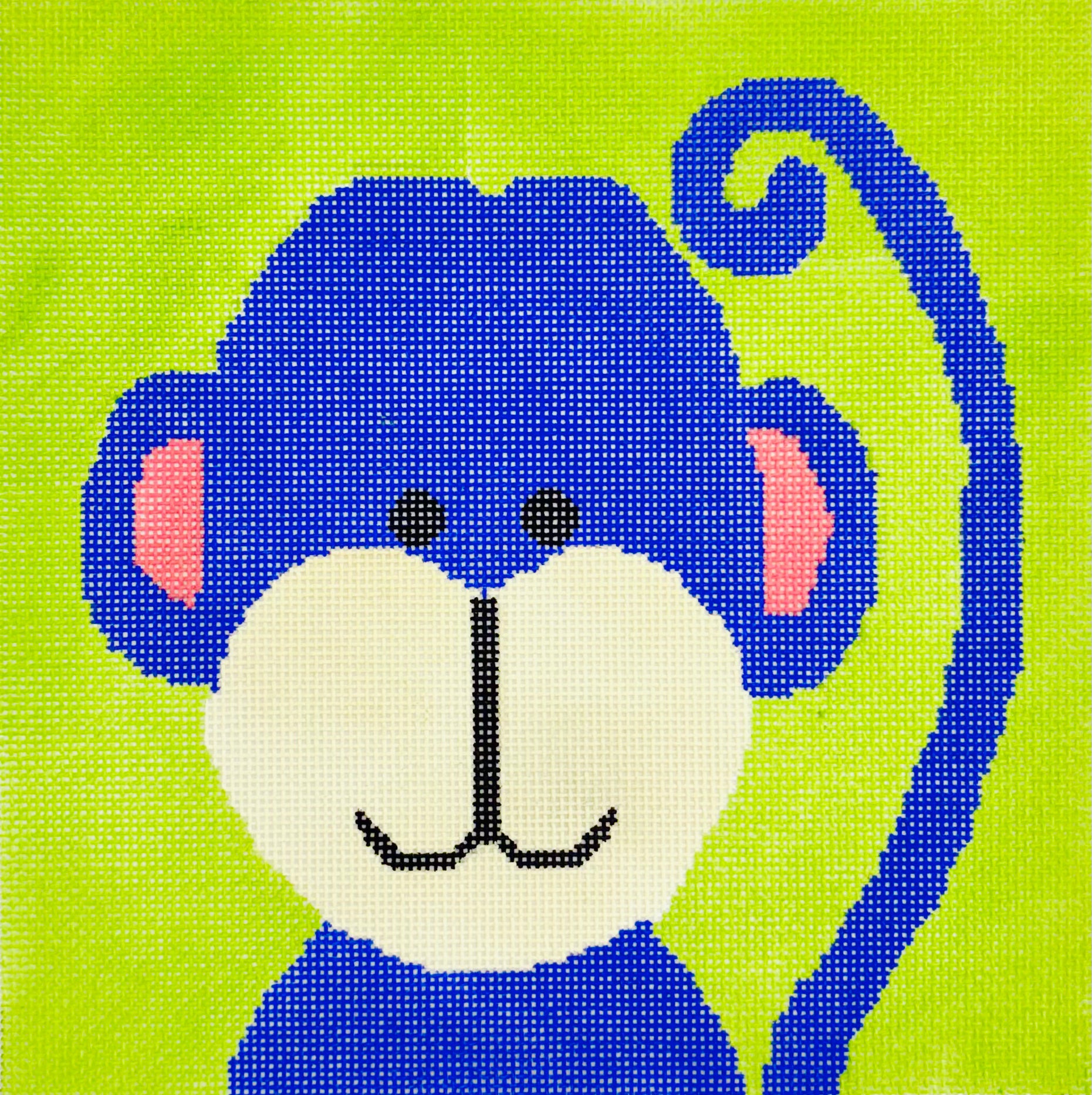 A Stitch in Time needlepoint canvas of blue monkey face and tail on a green background