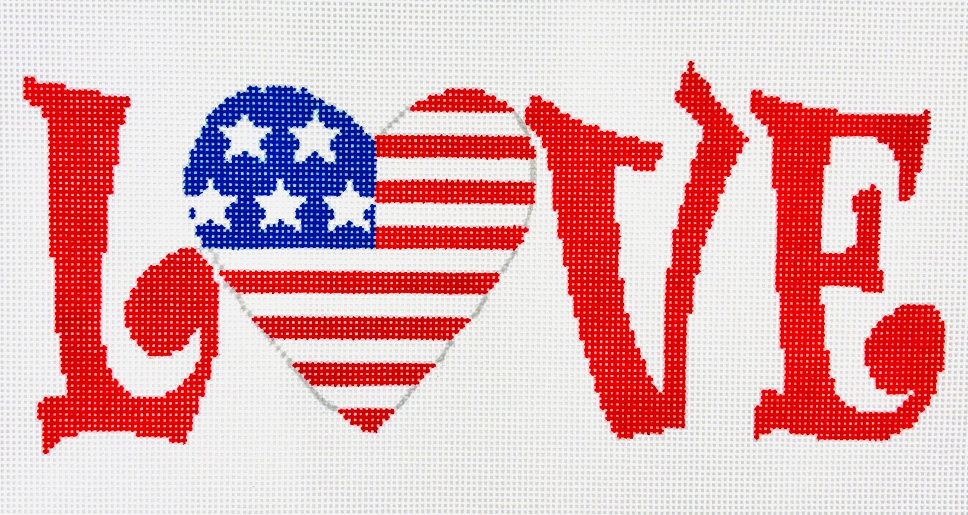 A Stitch in Time needlepoint canvas of the word 'LOVE' in red with an American flag heart design for the 'O' on a white background