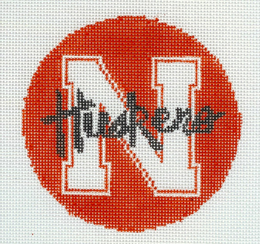 Kathy Schenkel round needlepoint canvas of big white 'N' and 'Huskers' black text with a red background