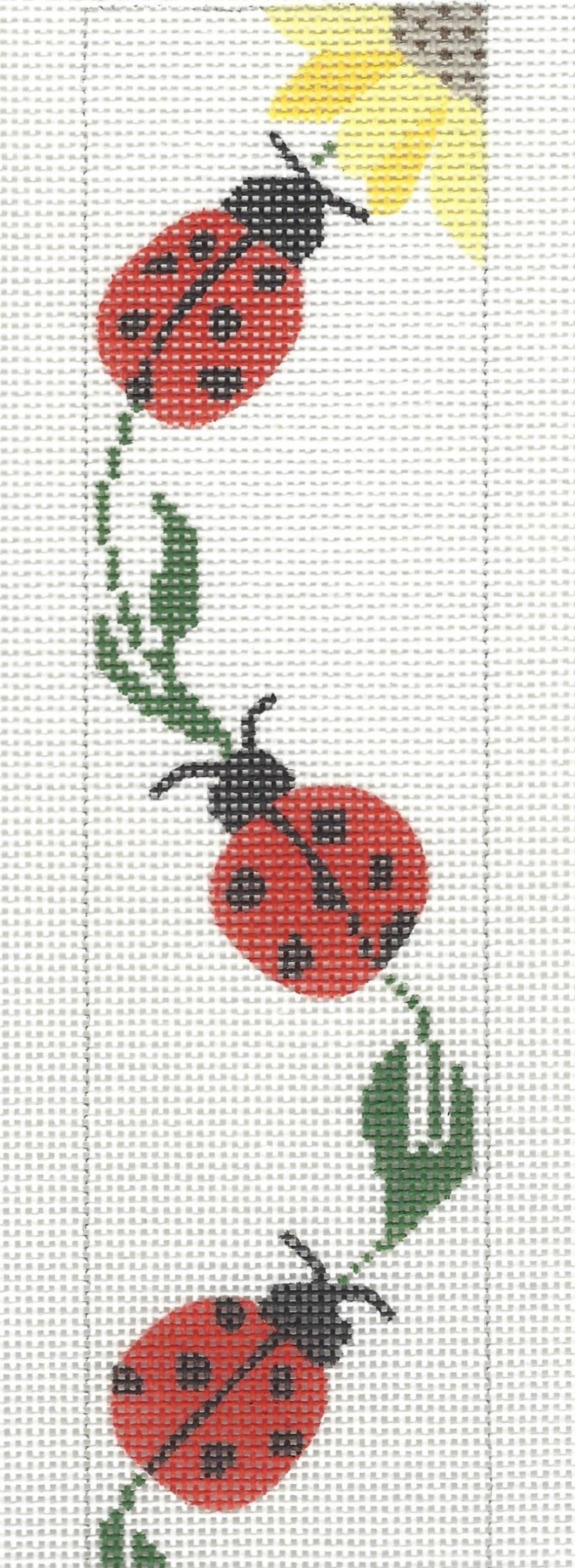 j. childs bookmark needlepoint canvas of three ladybugs and the corner of a sunflower on a white background