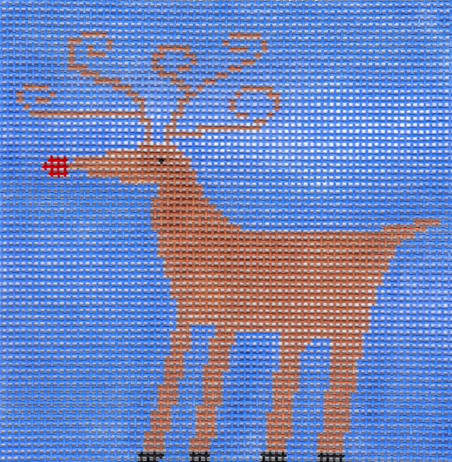 Treglown needlepoint canvas featuring a stylized brown reindeer with antlers and a red nose, set against a blue background.