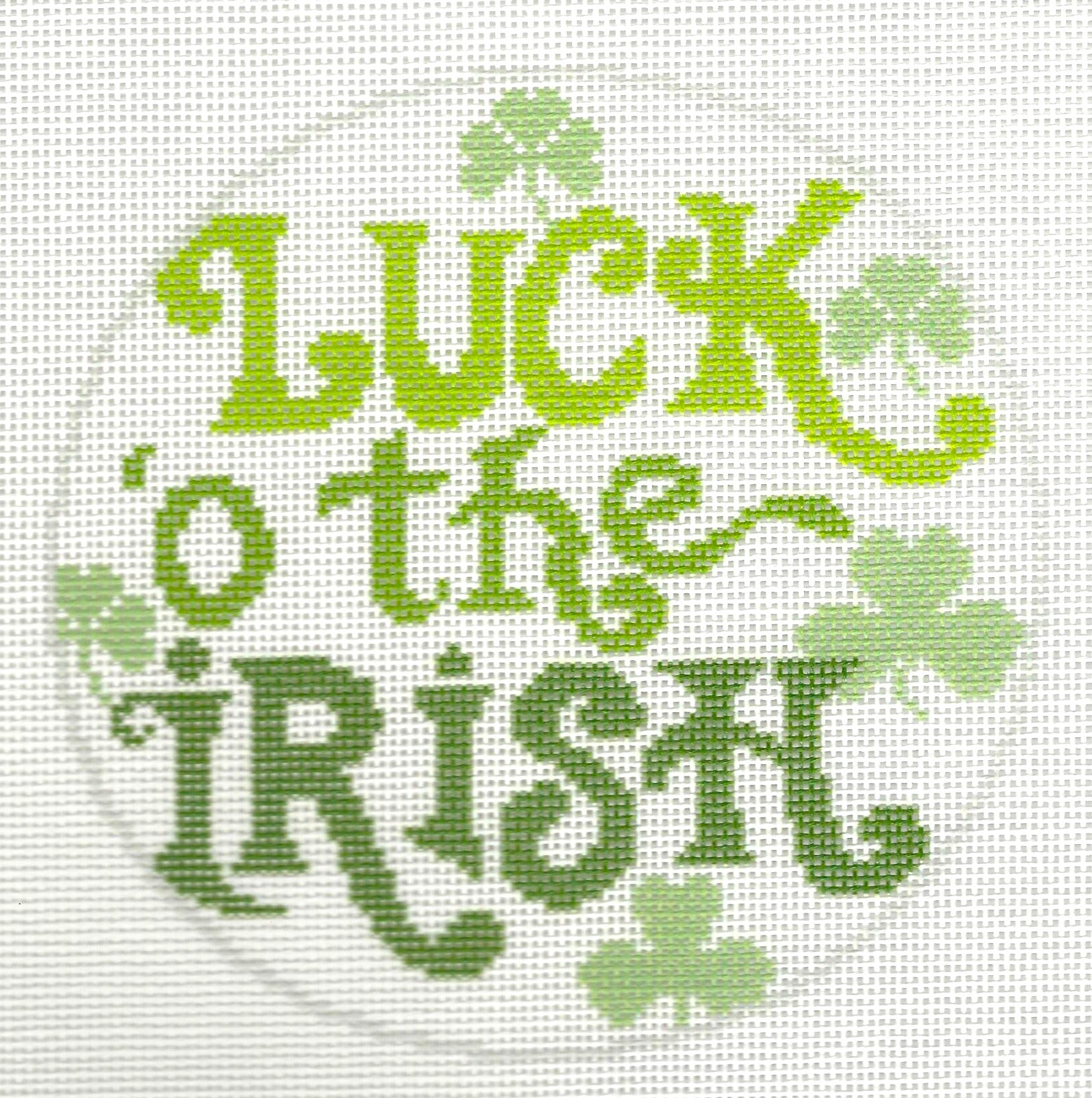 Needlepaint round needlepoint canvas with 'Luck o' the Irish' text and shamrocks on a white background