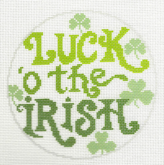 Needlepaint round needlepoint canvas with 'Luck o' the Irish' text and shamrocks on a white background