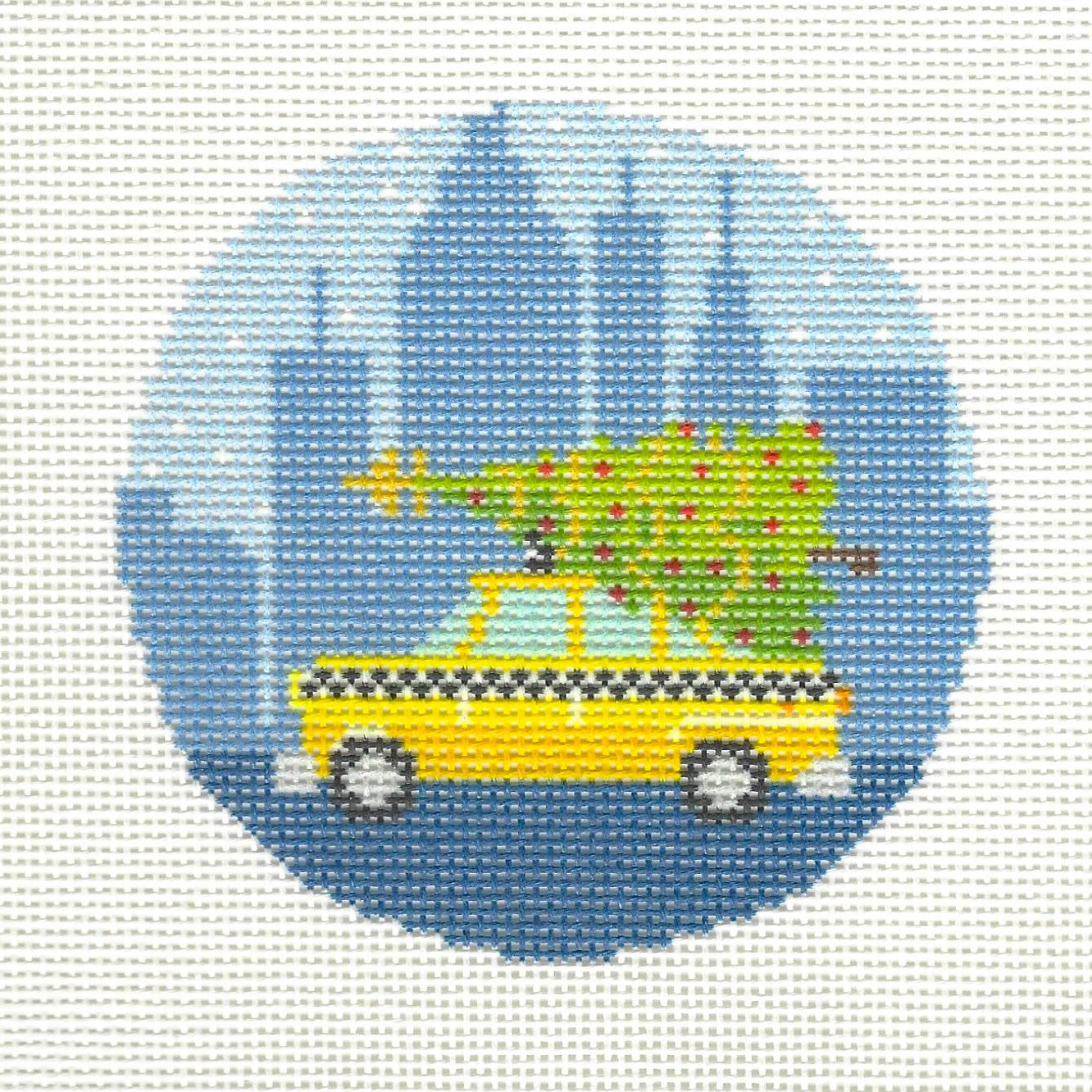 Kirk & Bradley round needlepoint canvas of yellow taxi with Christmas tree on top with NYC skyline in background